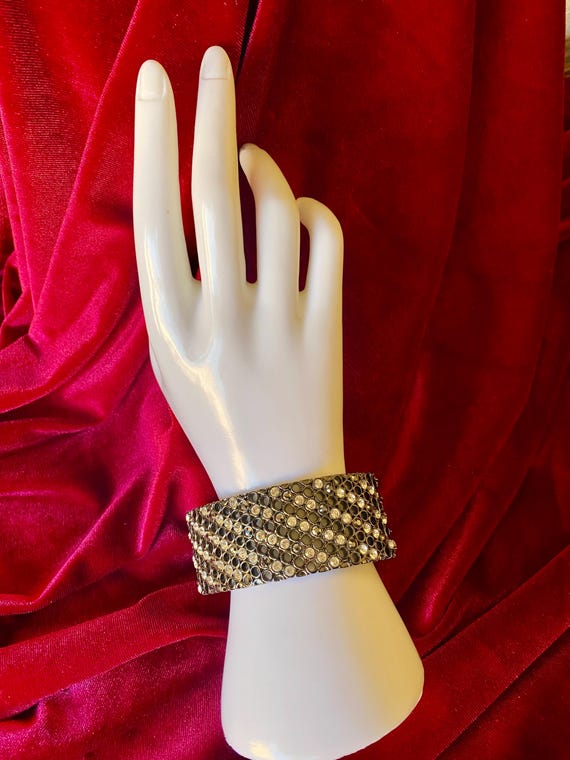 A wide cuff bracelet with multiple rows of clear … - image 1