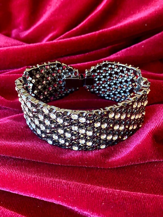 A wide cuff bracelet with multiple rows of clear … - image 8