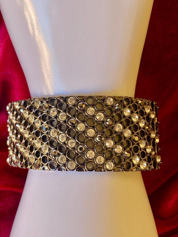 A wide cuff bracelet with multiple rows of clear … - image 4