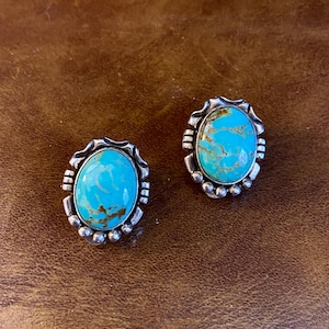 Carol Felley vintage Clip on Earrings, featuring oval-shaped prominent turquoise cabochons set in sterling silver.