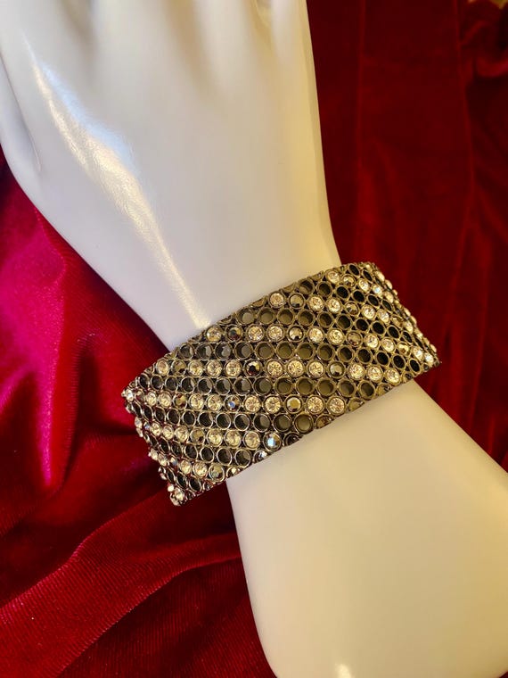 A wide cuff bracelet with multiple rows of clear … - image 3