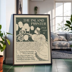 May include: A framed vintage poster titled The Inland Printer, July 1895, Volume XV Number 4. The print features a dark green background with cream-colored line art of a person in a hat holding a large floral parasol amidst hanging lanterns.