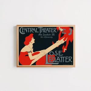 May include: A framed vintage poster featuring a black background with two figures in red clothing balancing on a long plank. The text reads CENTRAL THEATER, Alte Jacobstr. 30, Din J. Ferenczy, and LOSE BLÄTTER in grey lettering against the dark backdrop.