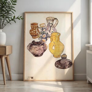 May include: A framed watercolor painting depicting a collection of six ceramic vessels, including pitchers and jars in shades of yellow, brown, and blue, with the text O.W. 1978 visible in the bottom left corner of the artwork.