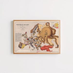 May include: A framed vintage political map titled John Bull et ses amis, dated 1900. The map depicts Europe as a collection of caricatured figures and a large central octopus with a human face, all rendered in muted earth tones within a wooden frame.