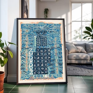 May include: A framed wall calendar print featuring a deep blue background with intricate, flowing botanical illustrations in lighter blue and orange. The calendar grid displays days of the week and numerical dates, with text at the top reading MET.