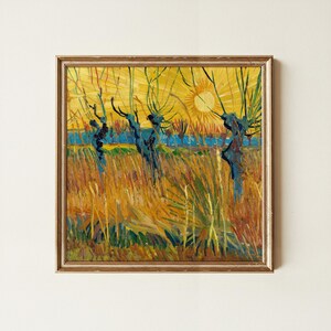 May include: A framed oil painting print featuring a vibrant landscape with a bright yellow sun, dark blue tree trunks, and golden wheat fields. The artwork is enclosed in a thin, metallic gold frame with a textured, weathered finish.