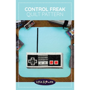 May include: A light blue quilt with a black and white controller design. The quilt features the text "CONTROL FREAK QUILT PATTERN". The design includes a black vertical stripe and a controller graphic with red and black buttons.