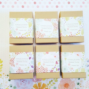 May include: Six small brown boxes with floral patterned labels. Each label reads "A Pocket of Posies" and "Handmade Jewelry" with a thank you message.