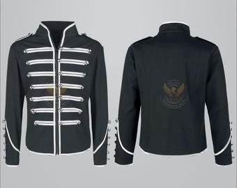 May include: Black military-style jacket with white trim and accents. The jacket features a high collar, decorative white stripes, and silver-colored buttons. The sleeves have button details at the cuffs. The back of the jacket has a gold emblem.