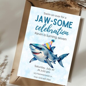May include: A birthday party invitation with a watercolor illustration of a smiling shark wearing a party hat. The invitation reads "Swim on over for a JAW-SOME celebration" and includes party details: date, time, and location.