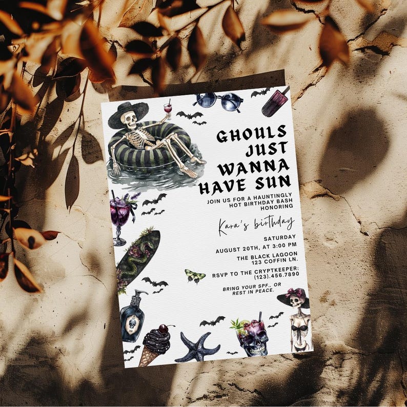May include: A white invitation card with the text "Ghouls Just Wanna Have Sun" and illustrations of a skeleton, bats, and other Halloween-themed graphics. The card is for Kara's birthday on August 20th.