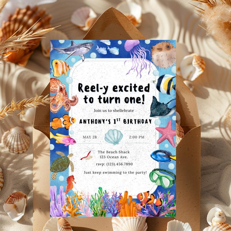 May include: A blue and white invitation with an underwater theme. The text reads "Reel-y excited to turn one!" with details for Anthony's 1st birthday. The invitation features illustrations of various sea creatures and coral.