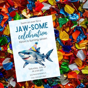 May include: A party invitation with a watercolor illustration of a shark wearing a party hat. The invitation reads "Swim on over for a JAW-SOME celebration. Kevin is turning seven." The background is a colorful confetti.