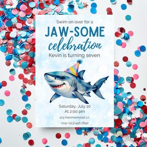 May include: A party invitation with a watercolor illustration of a smiling shark wearing a party hat. The invitation reads "Swim on over for a JAW-SOME celebration" and includes event details. Confetti in red, white, and blue surrounds the invitation.
