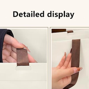 May include: A white paper gift bag featuring brown fabric ribbon handles. The image includes the text Detailed display at the top, showing a close-up view of the brown ribbon handle attached to the white paper surface of the bag.