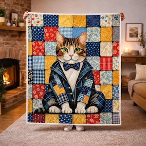 May include: A colorful patchwork quilt featuring a dapper cat illustration. The cat wears a blue plaid jacket and bow tie, with green eyes. The quilt has a variety of patterned squares in red, blue, yellow, and white, creating a cozy, decorative blanket.