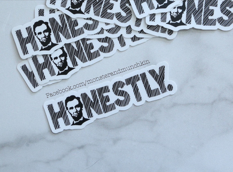 May include: A stack of white stickers with black text and a black and white image of Abraham Lincoln. The text on the stickers reads "Honestly" and "Facebook.com/monsterandmunchkin".