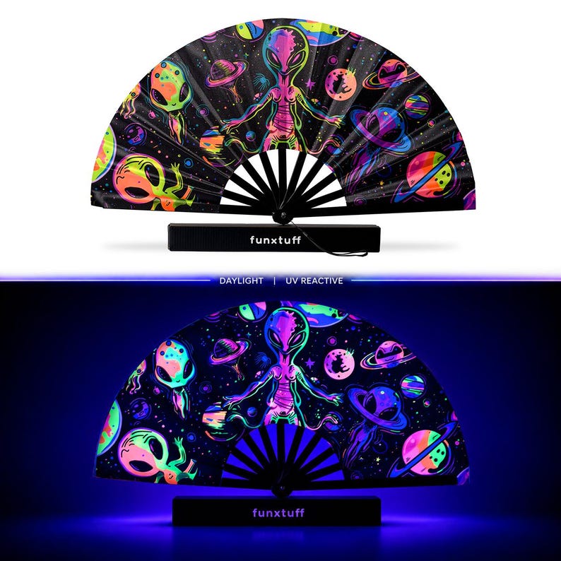 May include: A folding hand fan featuring a black background with a vibrant, multi-colored space theme including aliens, planets, and stars. The fan displays the text funxtuff on its base and is shown in both daylight and UV reactive lighting.