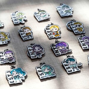 May include: A collection of sixteen metal enamel keychains, each featuring a unique anime-style character illustration paired with a four-letter personality type acronym such as INFJ, ENFP, ISTP, ISFP, ESTP, ESFP, ENTJ, INTP, ENTP, INTJ, ESFJ, and ISTJ.
