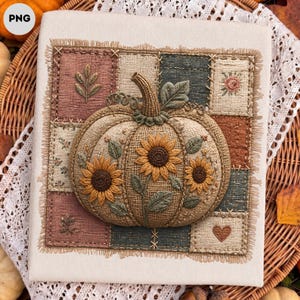 May include: A square fabric wall hanging featuring a central three-dimensional embroidered pumpkin decorated with yellow sunflowers and green leaves. The pumpkin is set against a patchwork background of textured squares in muted earth tones.