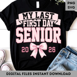 May include: Black t-shirt with the text "MY LAST FIRST DAY SENIOR 2026" in pink. A pink bow graphic is centered below the word "SENIOR". The shirt is paired with blue jeans and white sneakers.