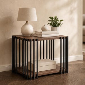 May include: A square side table with a dark wood top and a black metal frame. A beige lamp, books, a small vase, and a potted plant sit on the table. A beige box is on the lower shelf. The room has a neutral color palette.