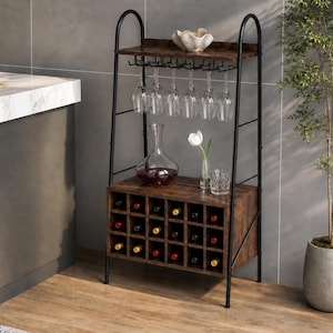 May include: A freestanding wine rack with a black metal frame and dark wood shelves. The unit features a top shelf for storage, a hanging rack for stemware, and a lower cabinet with twenty individual cubbies for wine bottles.