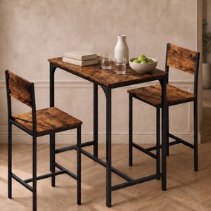 May include: A small dining set with a rectangular table and two matching chairs. The table and chairs have a dark wood grain finish and black metal frames. The table is set with a white vase, glasses, and a bowl of green fruit.