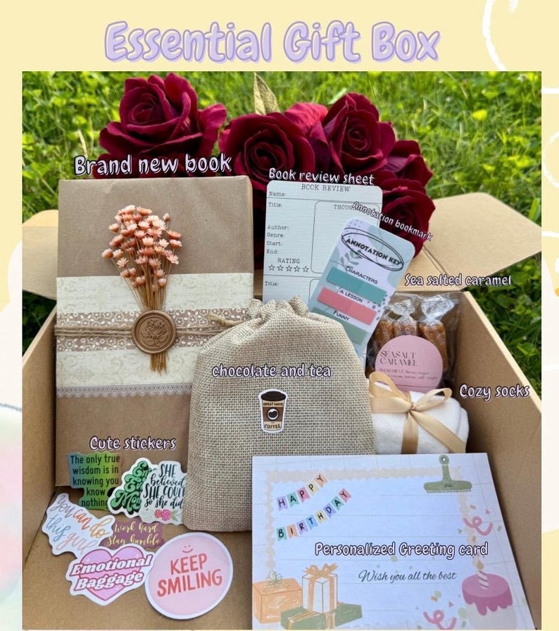 May include: An open gift box filled with a brand new book, a book review sheet, annotation bookmarks, sea salted caramel, cozy socks, chocolate and tea, cute stickers, and a personalized birthday greeting card. The box is decorated with red roses.