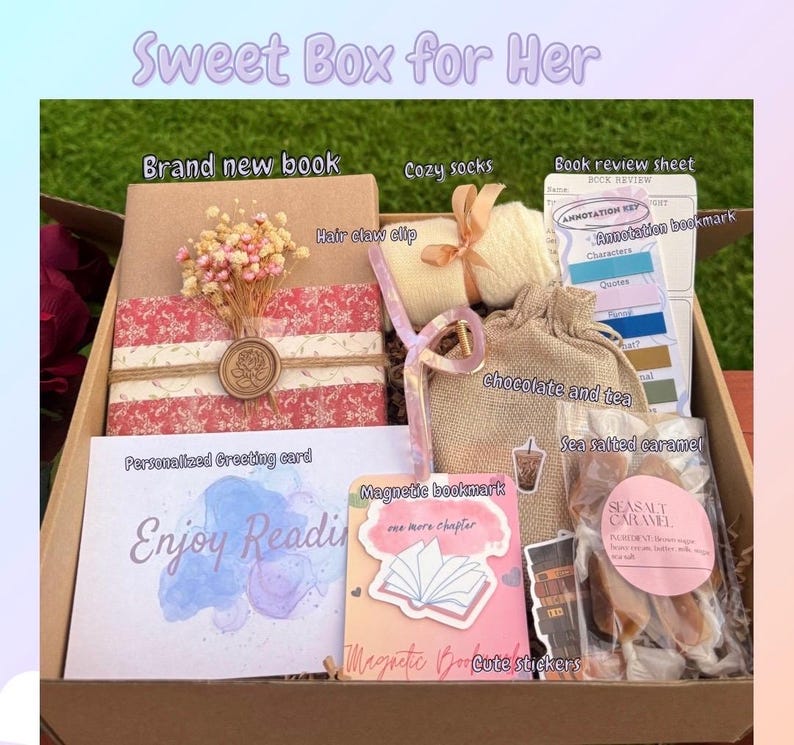 May include: A gift box labeled "Sweet Box for Her" filled with a brand new book, cozy socks, a hair claw clip, a book review sheet, a personalized greeting card, chocolate, tea, sea salted caramel, and magnetic bookmarks. The card says "Enjoy Reading".