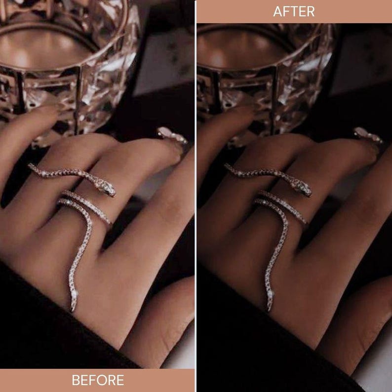May include: A silver-toned snake ring with clear, sparkling stones wraps around a finger. The ring features a snake head and tail design, with the body of the snake winding around the finger. The image is set against a dark background.