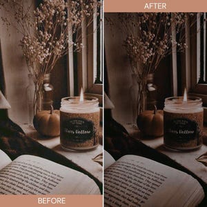 May include: A lit candle in a glass jar with a cork label that reads "Stars Hollow". The candle sits on a table next to a book and a small pumpkin. Dried flowers are in a glass vase in the background.