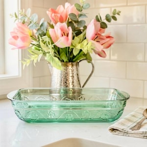 May include: A set of three ceramic nesting bowls in shades of blue, green, and white. The bowls feature a speckled glaze and a simple, modern design. The largest bowl measures approximately 6 inches in diameter.