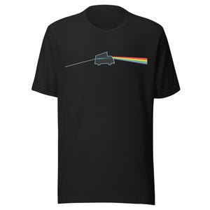 May include: Black t-shirt with a camper van graphic and a rainbow prism effect. A white line extends from the van to a spectrum of colours. The shirt is made of a soft material.