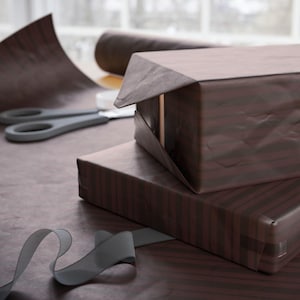 Brown striped gift wrap, timeless and versatile for birthdays, Christmas, and seasonal occasions.