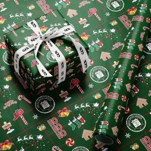 May include: A wrapped present with a white ribbon and a roll of matching wrapping paper. The green paper features a festive pattern of Christmas icons, including gingerbread houses, candy canes, and Santa's sleigh.