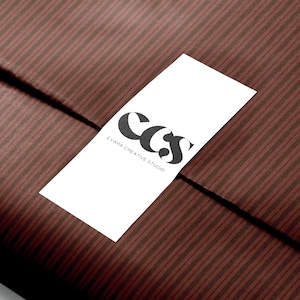 Brown striped gift wrapping paper with vertical lines, perfect for fall gifting and holiday celebrations.