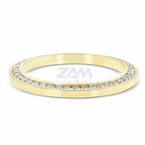 May include: A gold band ring with a row of small, clear gemstones set around the outer edge. The ring is a simple, elegant design, perfect for everyday wear. The ring is a size 7.