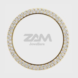 Könnte beinhalten: Ein goldfarbener Ring mit zwei Reihen kleiner, klarer Edelsteine. Der Ring hat eine kreisförmige Form, und die Edelsteine sind eng um das Band gesetzt. Der Text "ZAM Jewellers" ist in der Mitte des Rings zu sehen.