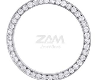 May include: A silver watch bezel set with a ring of small, clear gemstones. The gemstones are evenly spaced around the bezel. The text "ZAM Jewellers" is in the centre of the bezel.