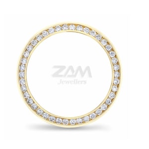 May include: A gold-colored, circular jewelry piece with a ring of small, clear gemstones set around the outer edge. The center of the piece has the text "ZAM Jewellers" in a stylized font.