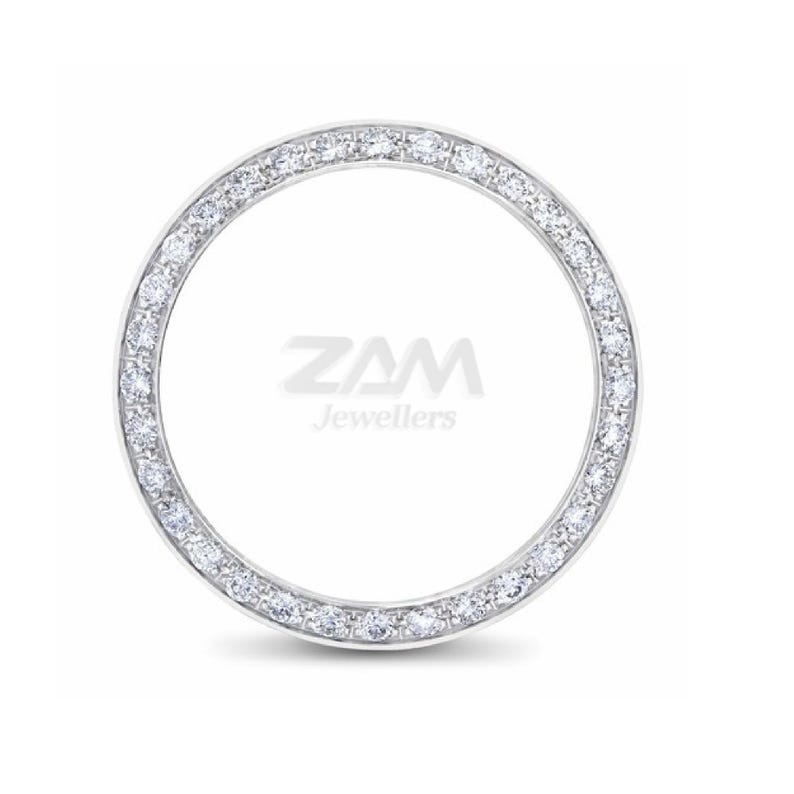 May include: A circular ring with a band of small, sparkling diamonds. The ring is set against a white background. The text "ZAM Jewellers" is in the center of the ring.
