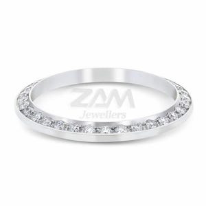 May include: A silver ring with a band of small, clear gemstones. The ring has a polished finish and the text "ZAM Jewellers" is visible in the center.