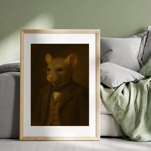 May include: A framed sepia-toned portrait of a mouse wearing a suit, vest, bow tie, and round glasses. The mouse is the focal point, set against a dark background. The artwork is in a wooden frame.