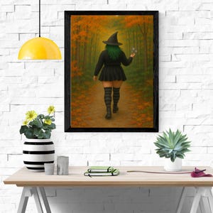 May include: A framed print shows a person in a witch costume walking along a path in a forest. The person is wearing a black witch hat, dress, and striped socks. The forest has orange and green foliage.