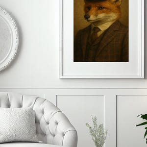 May include: Framed portrait of a fox wearing a bowler hat, suit, and tie. The fox has orange fur and is set against a warm, neutral background. The suit is brown with a plaid pattern. The artwork is displayed in a white frame.