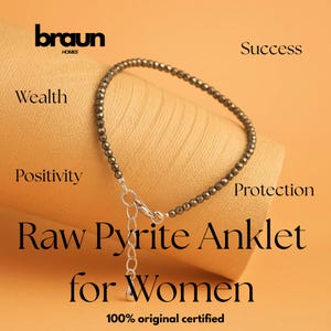 May include: A raw pyrite anklet with a silver clasp and extender chain. The anklet is made of small, dark gray beads. The image includes the text "Raw Pyrite Anklet for Women" and the Braun Homes logo.