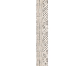 May include: A rectangular beige table runner with a geometric pattern in black and gray. The runner has a fringed edge on both ends. The design includes diamond and dotted patterns.