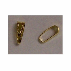 May include: Two gold-colored metal jewelry findings. One is a small, oval-shaped loop. The other is a V-shaped pendant bail with a decorative edge.